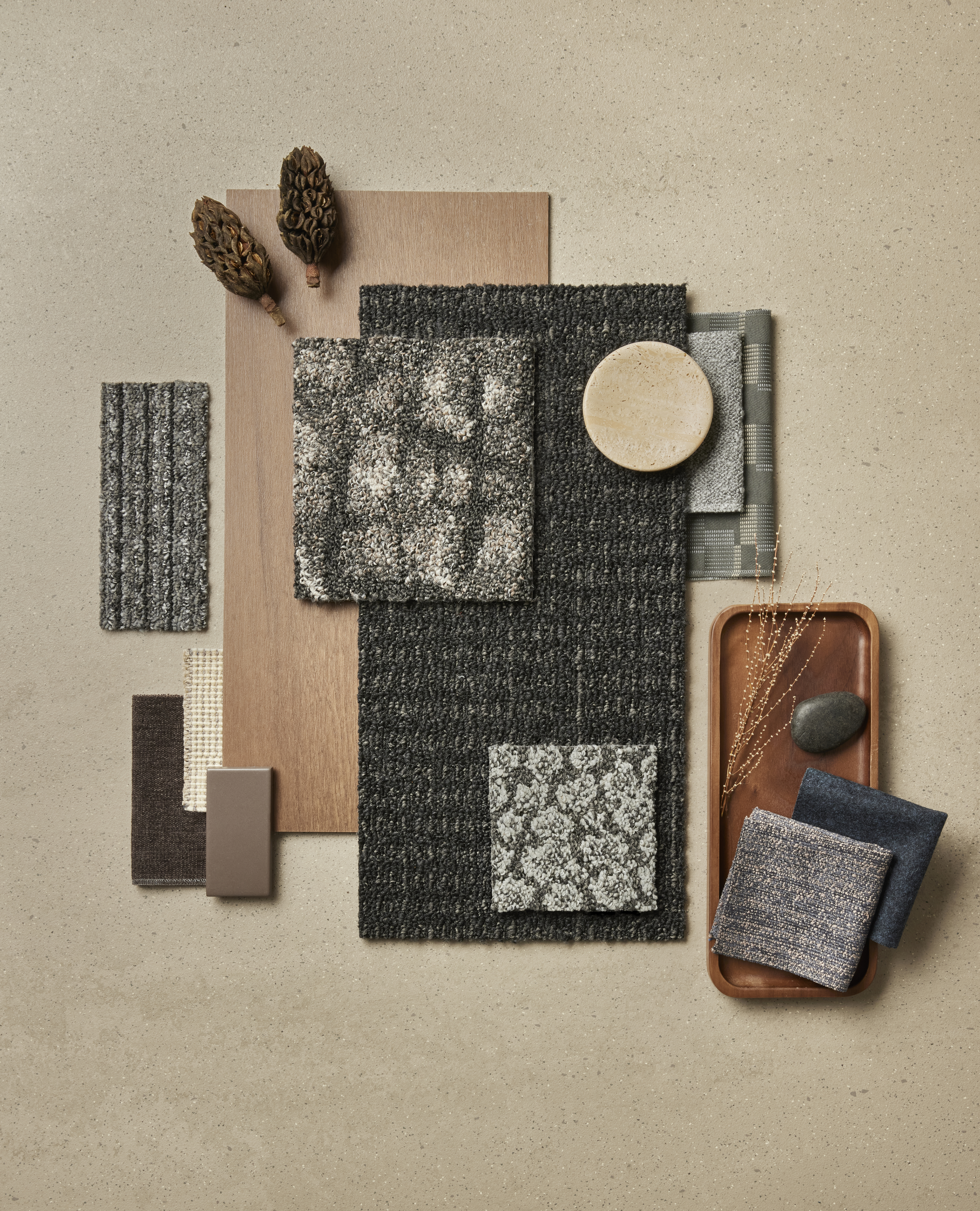 Tabletop palette of Interface Etched & Threaded carpet tiles with Earthen Forms LVT and norament castello rubber